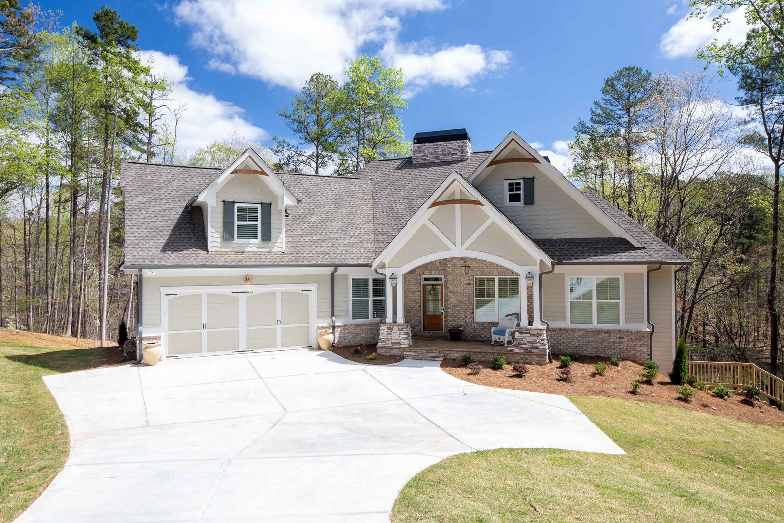 Craftsman front elevation with driveway and stone columns — Imbriale, custom home built by Ironwood Construction Group